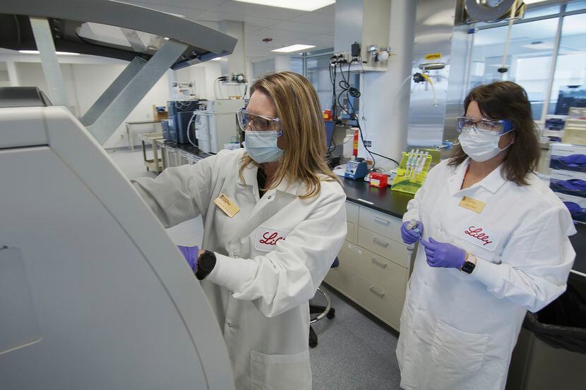 In this May 2020 photo provided by Eli Lilly, researchers prepare cells to produce possible...
