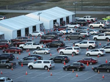 Vehicles line up Tuesday at the new drive-through COVID-19 vaccination clinic at Texas Motor Speedway in Fort Worth.
