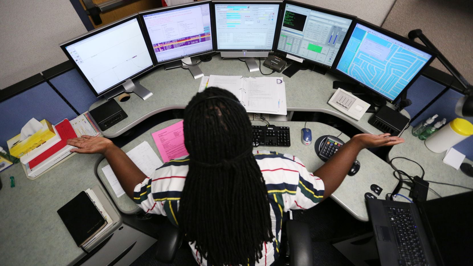 Ward Hughes, of Irving, reacts to a 911 caller inside the dispatch center on the lower level in Plano Municipal Center in Plano in this 2014 photo. Dispatchers in Irving can now respond to text messages to 911.