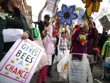Samantha Norman, 9, center, and other children chant before the March for Science in New...