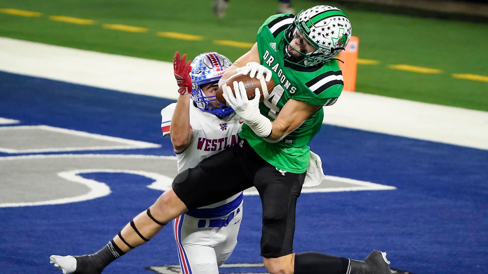Southlake Carroll wide receiver Brady Boyd (14) catches a 27-yard touchdown pass as Austin Westlake defensive back Jax Crockett (4) defends during the second quarter of the Class 6A Division I state football championship game at AT&T Stadium on Saturday, Jan. 16, 2021, in Arlington, Texas.