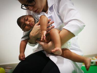 Dr. Stella Guerra performs physical therapy on an infant born with microcephaly at the...