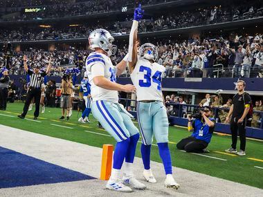 Dallas Cowboys running back Malik Davis (34) celebrates with quarterback Cooper Rush (10)...