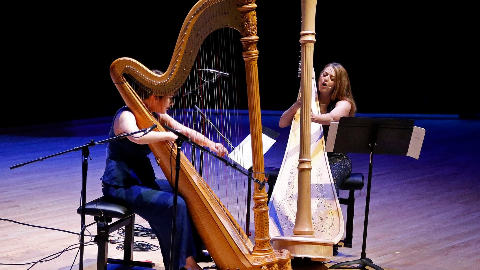 Harpists Emily Levin (left) and Michelle Gott sing while playing harp in a performance of German composer Karlheinz Stockhausen's "Freude" from "Klang" during the Voices of Change concert at Southern Methodist University's Caruth Auditorium in Dallas on Nov. 7.