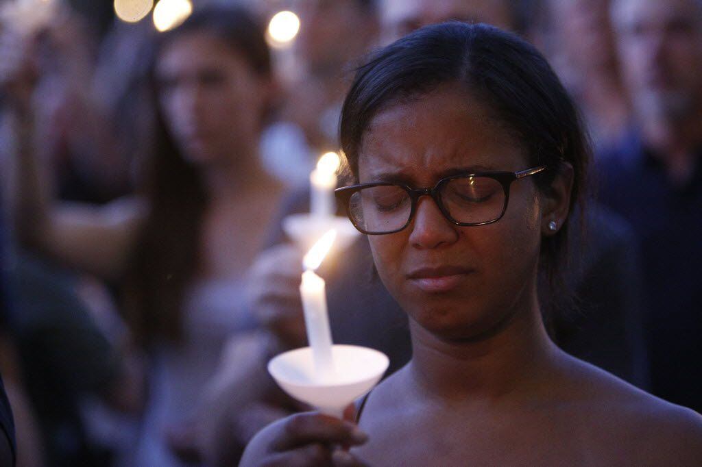 The crowd holds candles in memory of the victims of the police shootings  during a candlelight vigil hosted by the Dallas Police Association at Dallas City hall in Dallas, TX July 11, 2016. (Nathan Hunsinger/The Dallas Morning News)