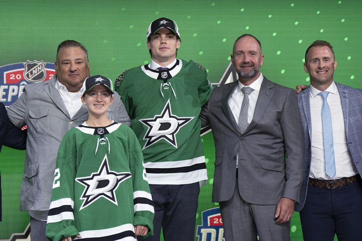 Lian Bichsel poses with Dallas Stars officials after being selected during  the first round...