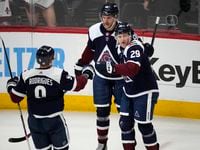 Colorado Avalanche center Nathan MacKinnon, right, is congratulated by right wing Mikko...