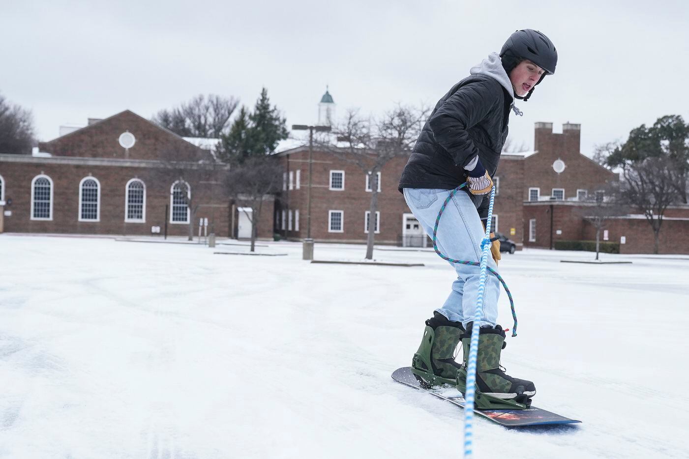 Owen Hattendorf, 17, snowboards while pulled by a vehicle in Preston Hollow Presbyterian...