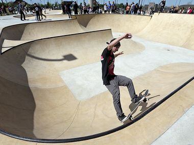 Jarod  Bookout, 16, of Azle practices on his skateboard at the new McKinney Skate Park grand...