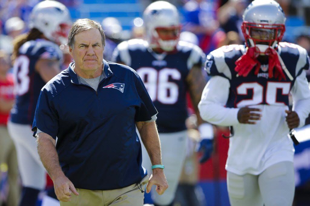 New England Patriots head coach Bill Belichick walks the field before an NFL football game...