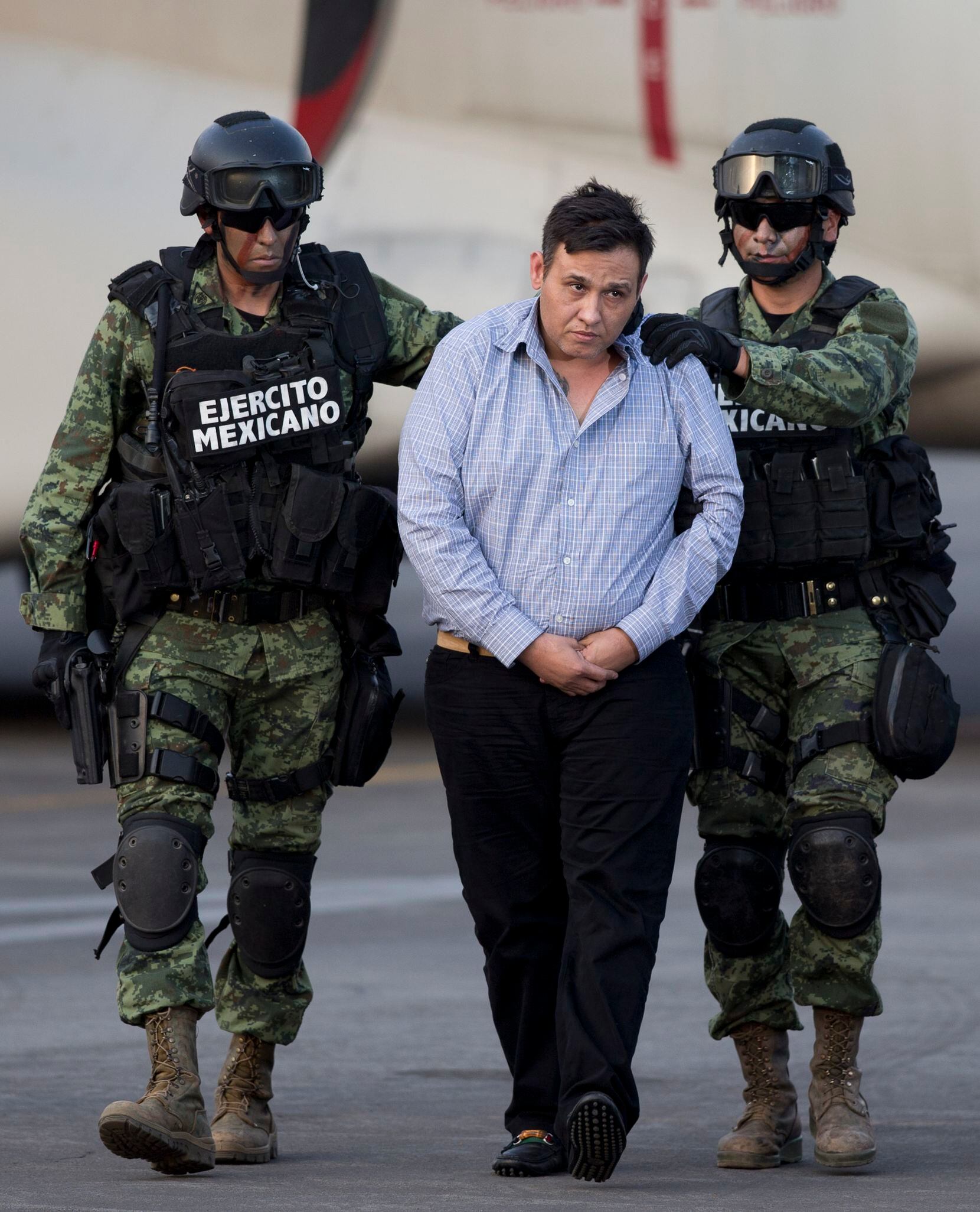 Soldiers escorted Omar Trevino Morales, leader of the Zetas drug cartel, as he was moved from a military plane to a military vehicle in Mexico City on March 4, 2015.