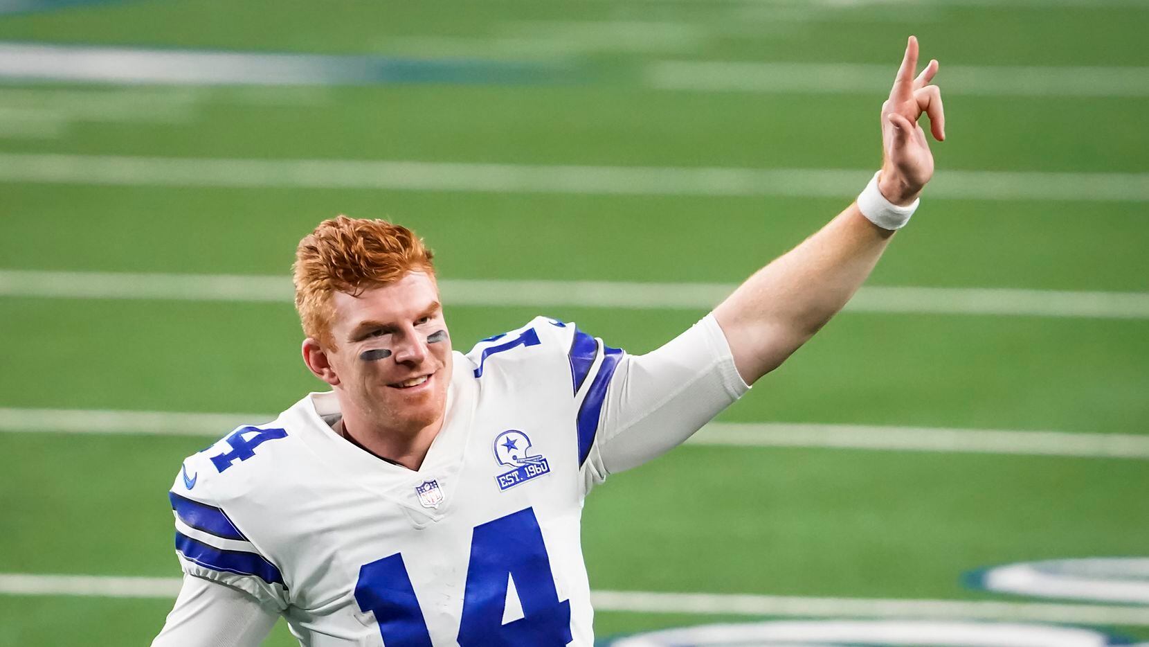 Dallas Cowboys quarterback Andy Dalton celebrates as he leaves the field after a win over...
