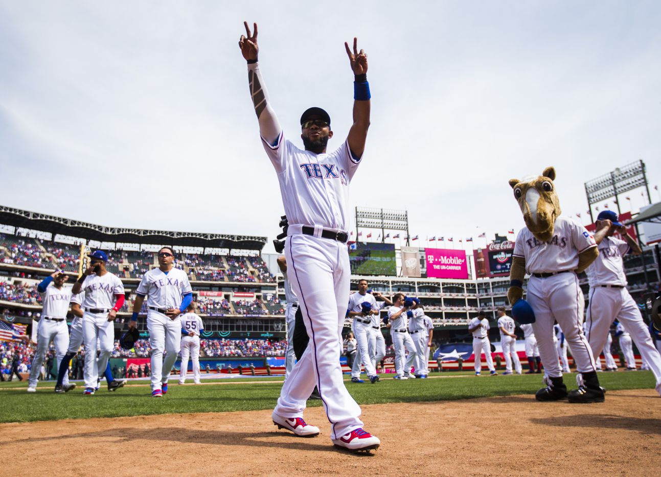 Texas Rangers shortstop Elvis Andrus (1) waves to fans as he heads to the dugout before an...