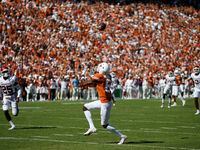 Texas wide receiver Joshua Moore (6) catches a pass and runs it in for a touchdown during the first half of an NCAA college football game against Oklahoma at the Cotton Bowl in Fair Park, Saturday, October 9, 2021.