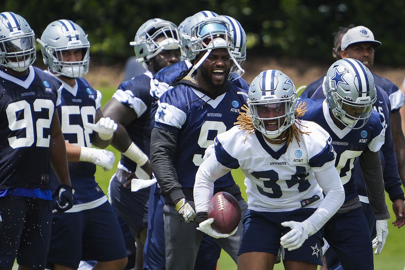 Dallas Cowboys running back Rico Dowdle (34) gets past cornerback Anthony Brown (30) as linebacker Jaylon Smith (9) reacts during a minicamp practice at The Star on Tuesday, June 8, 2021, in Frisco. (Smiley N. Pool/The Dallas Morning News)