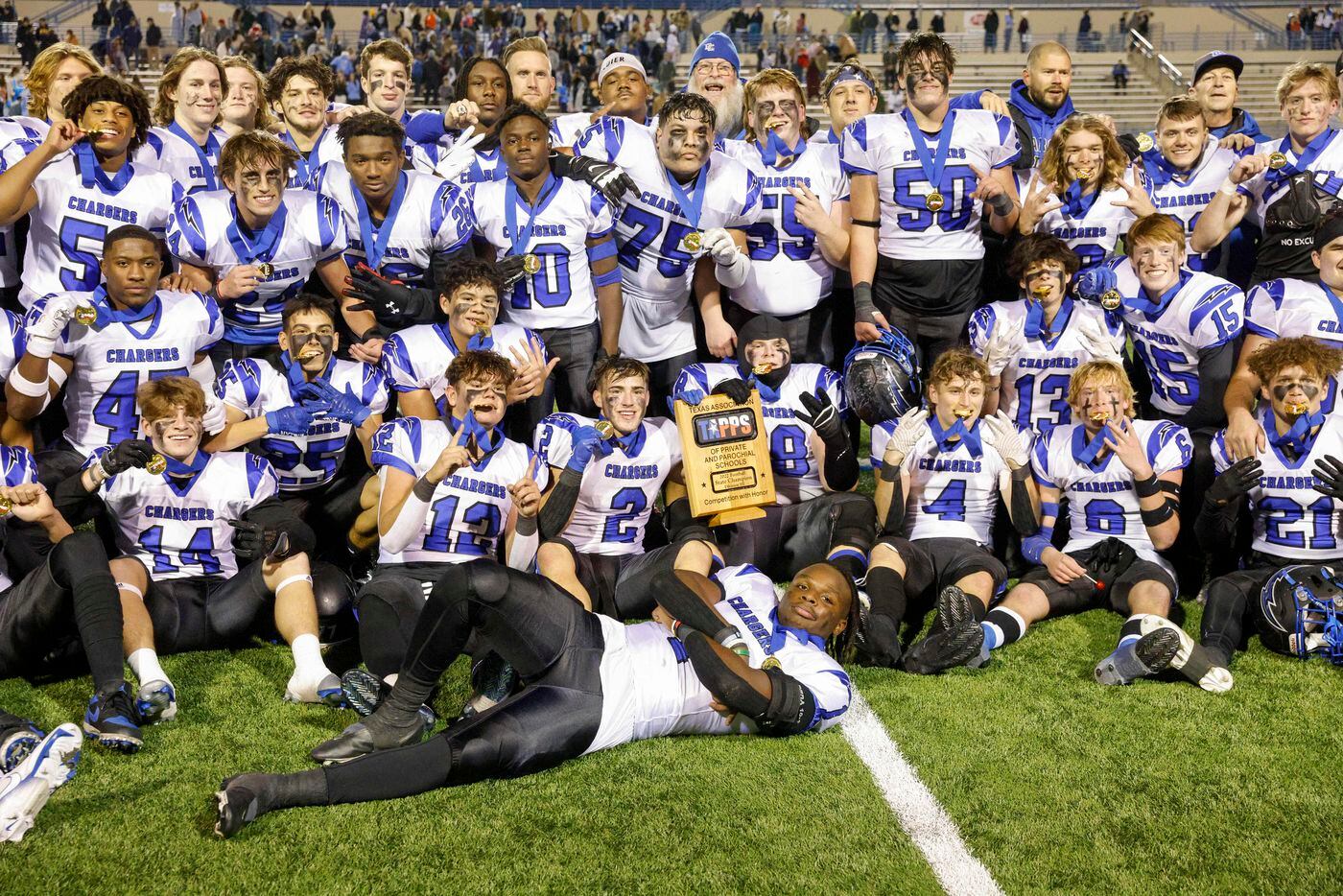 Dallas Christian players pose for photos after winning the TAPPS Division III state...