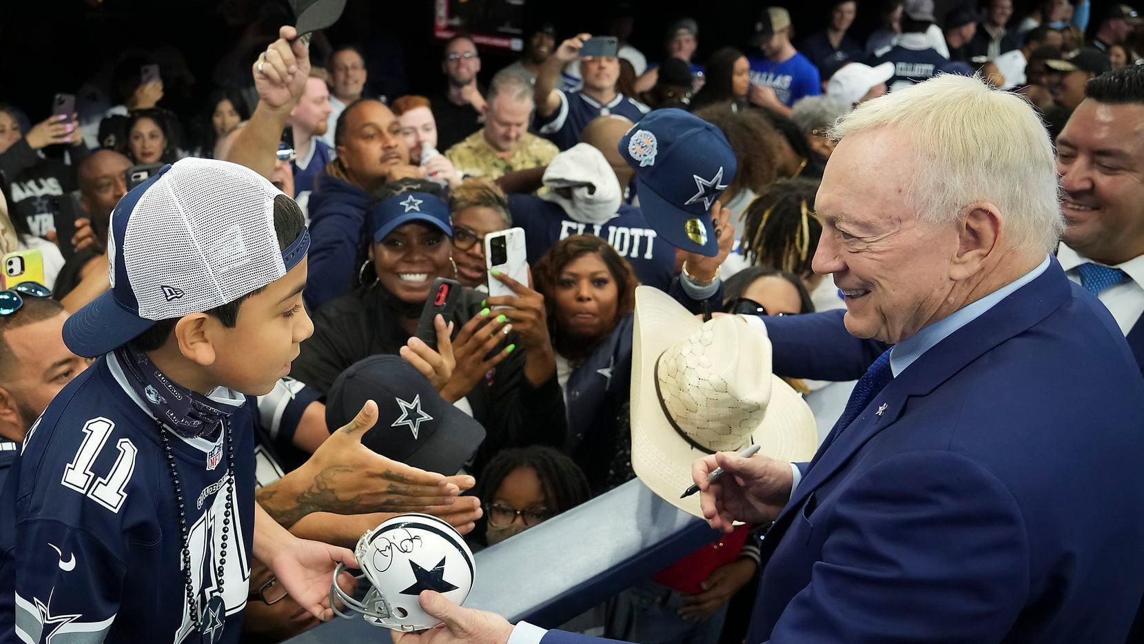 Dallas Cowboys owner and general manager Jerry Jones signs autographs for fans before an NFL...
