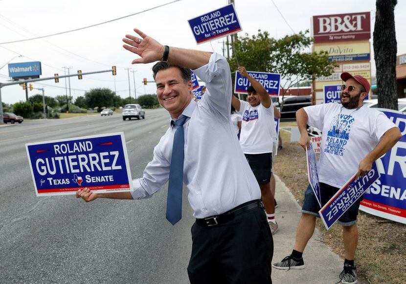 State Rep. Roland Gutierrez, a Democrat, campaigns with his volunteers on Tuesday, July 31,...