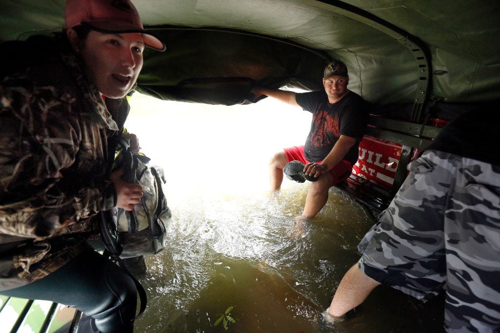 Christina Crump (left) reacts as flood waters rush into the bed of a military-type hauler after it drove into deep water while evacuating distressed residents from their flooded Dickinson, Texas homes flooded by rains from Hurricane Harvey, Monday, August 28, 2017. Residents were transported to City Hall and the First Baptist Church for transport to the Brown Convention Center in Houston. Tropical Storm Harvey continued to dump copious amounts of rain on the Houston area making a lot of the city impassable. (Tom Fox/The Dallas Morning News)