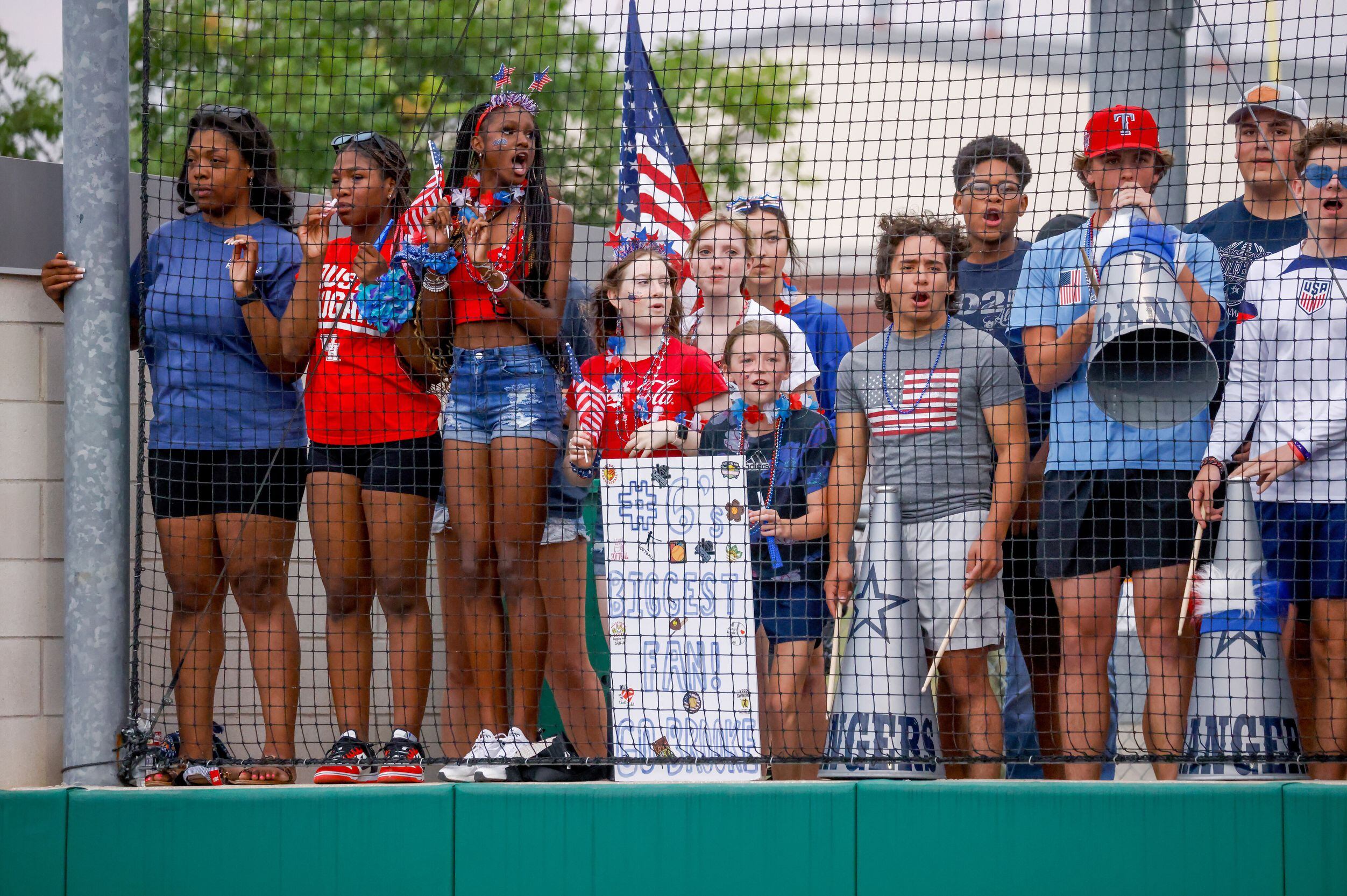 Frisco Lone Star fans move up against the netting as they cheer during a one-game Class 5A...