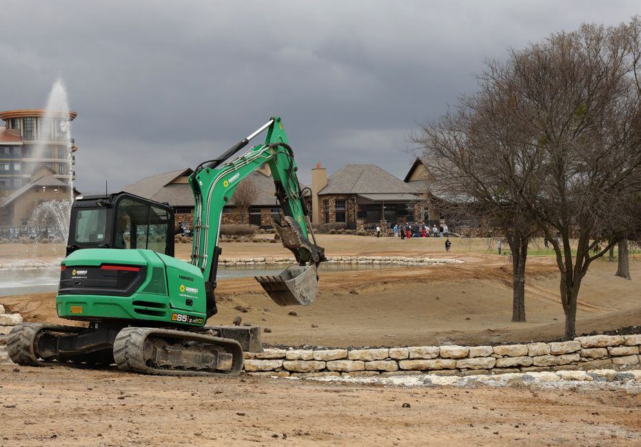 Workers prepare for the Byron Nelson tournament at TPC Craig Ranch in McKinney on March 9,...