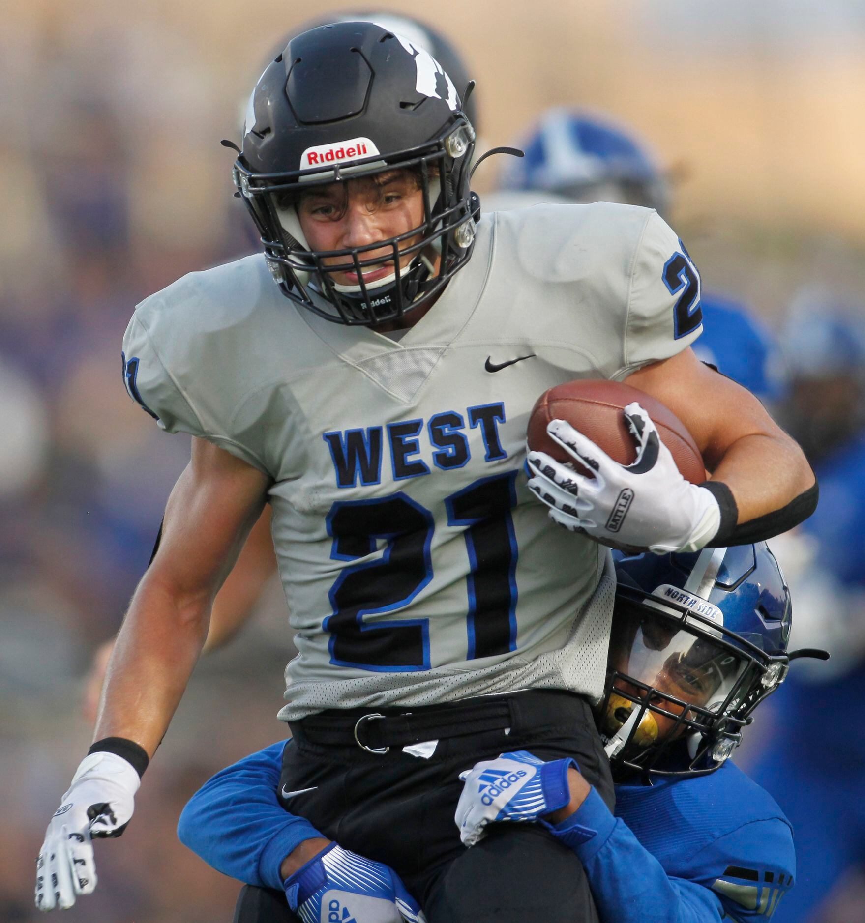Plano West running back Dermot White (21) rambles into the North Mesquite secondary before...