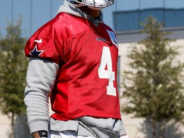 Dallas Cowboys quarterback Dak Prescott (4) talks with reporters while wearing a brace on...