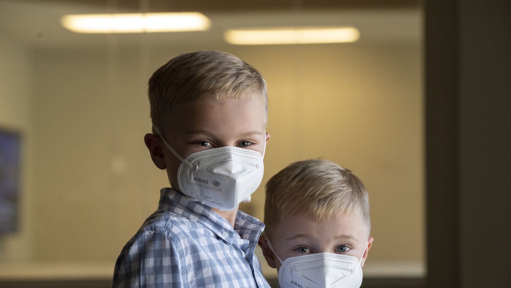 William Bielamowicz, 8, left, and his little brother Matthew, 6, wear KID95 masks designed...
