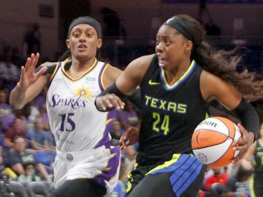 Dallas Wings guard Arike Ogunbowale (24) drives to the basket past the defense of LA Sparks...