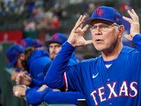 Texas Rangers manager Bruce Bochy motions toward home plate before an exhibition baseball...