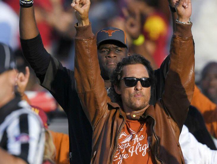 Matthew McConaughey (front) and former Texas quarterback Vince Young make the "Hook 'Em...