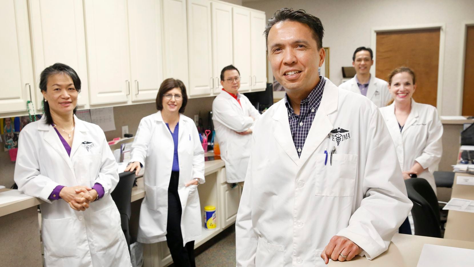 Dr. Stephen Buksh (foreground), a Euless doctor for 21 years, is pictured with fellow...