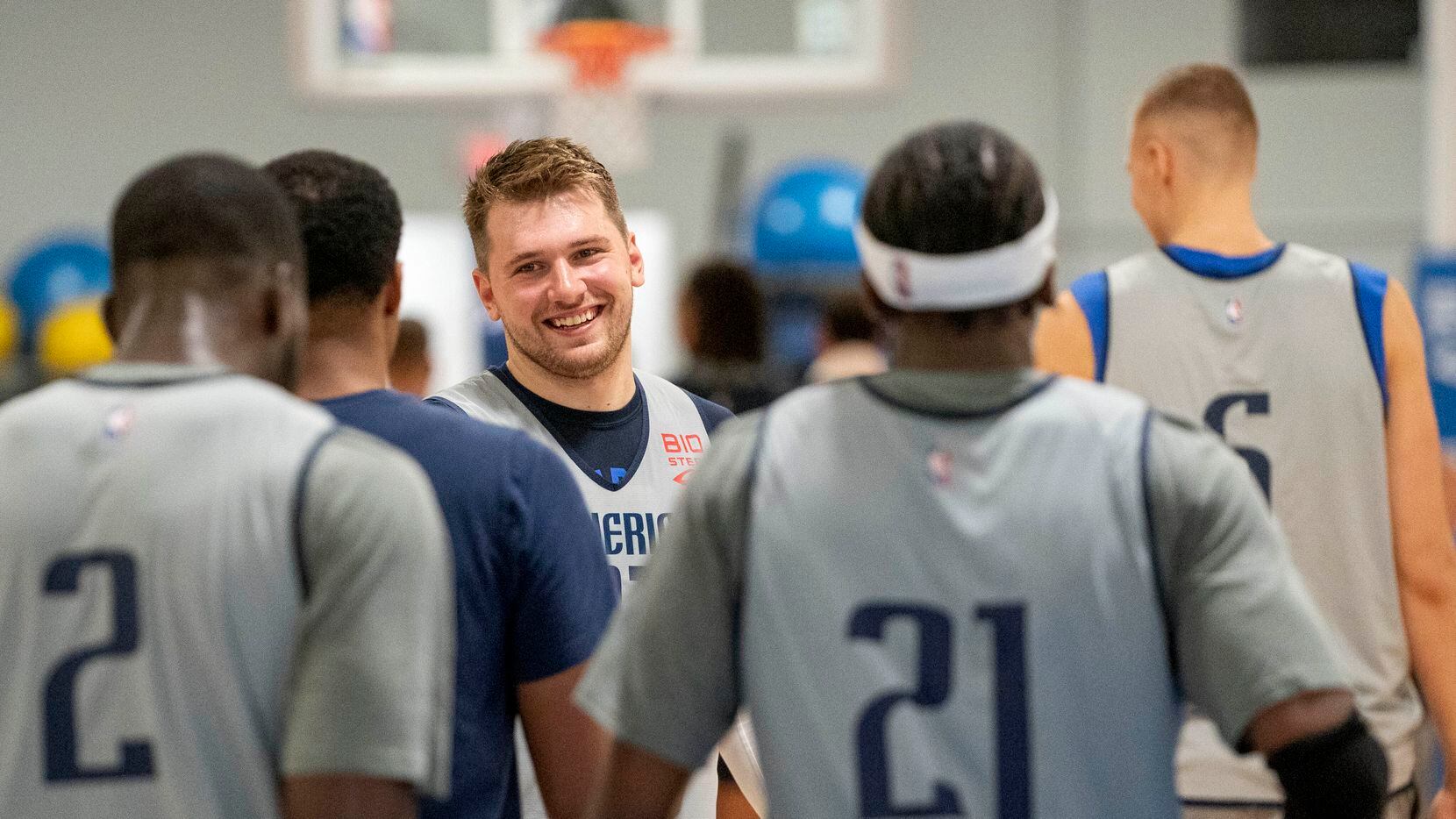 Dallas Mavericks guard Luka Dončić laughs with teammates during the first practice of...