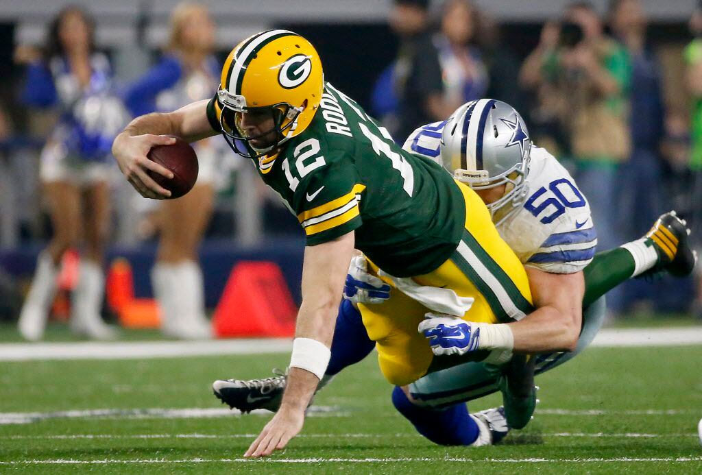 Green Bay Packers quarterback Aaron Rodgers (12) is tackled by Dallas Cowboys outside...