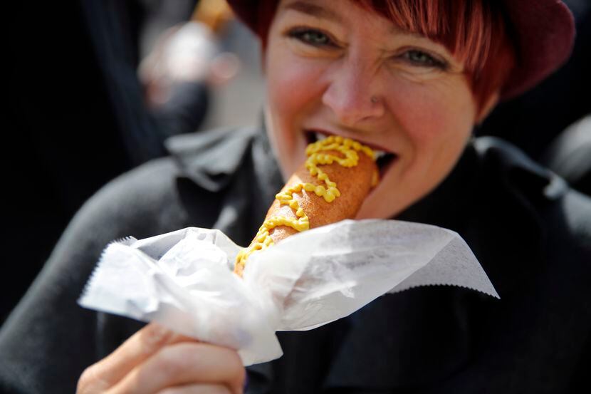 Kristen Murray of Dallas eats a Fletcher's corny dog in 2017.