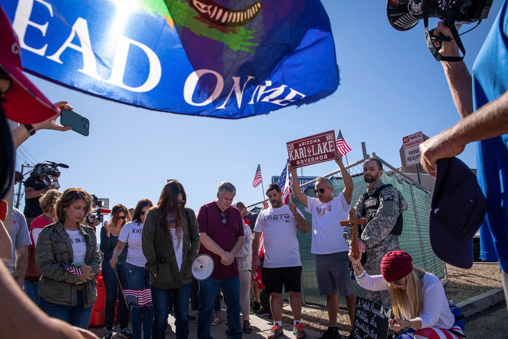 Republican supporters stand outside the Maricopa County Recorder's Office to protest what...