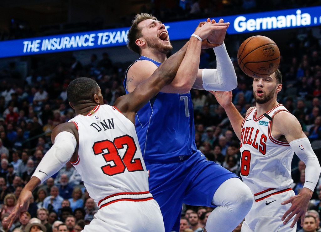 Dallas Mavericks forward Luka Doncic (77) is blocked as he goes up for a shot past Chicago...