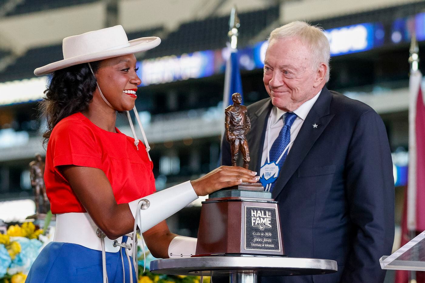 Dallas Cowboys owner Jerry Jones smiles as a member of the Kilgore College Rangerettes presents him with his Cotton Bowl Hall of Fame trophy during an induction ceremony at AT&T Stadium on Tuesday, Oct. 5, 2021, in Arlington.
