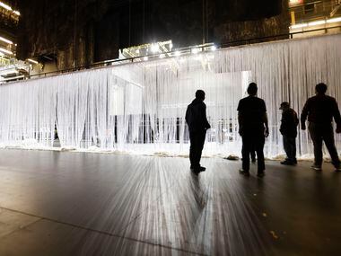 The AT&T Performing Arts Center crew sets up a curtain that will be used for projections...