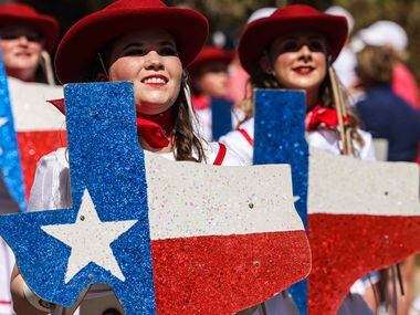 Participants march in the annual opening day parade at the State Fair of Texas in Dallas on...