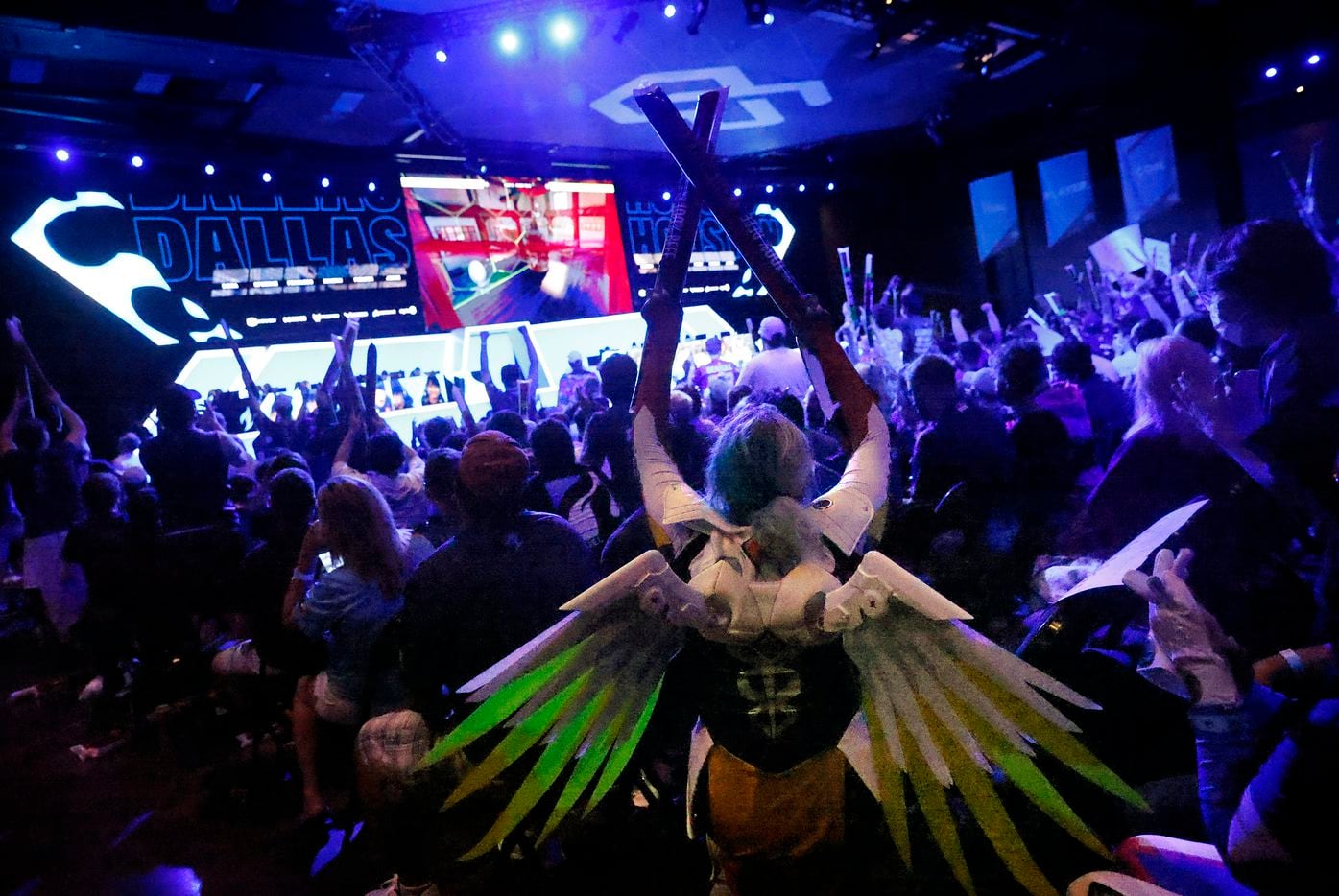 Dallas Fuel fan Hope Hopkins of Alvarado, Texas came dressed as Mercy, a character from Overwatch League. She another fans cheered as the Fuel won a map during their match against the Houston Outlaws at Esports Stadium Arlington Friday, July 9, 2021. Dallas Fuel defeated Houston in The Battle for Texas, 3-0. It was the first in-person live competition for fans in over a year. Houston competed from their hometown. (Tom Fox/The Dallas Morning News)