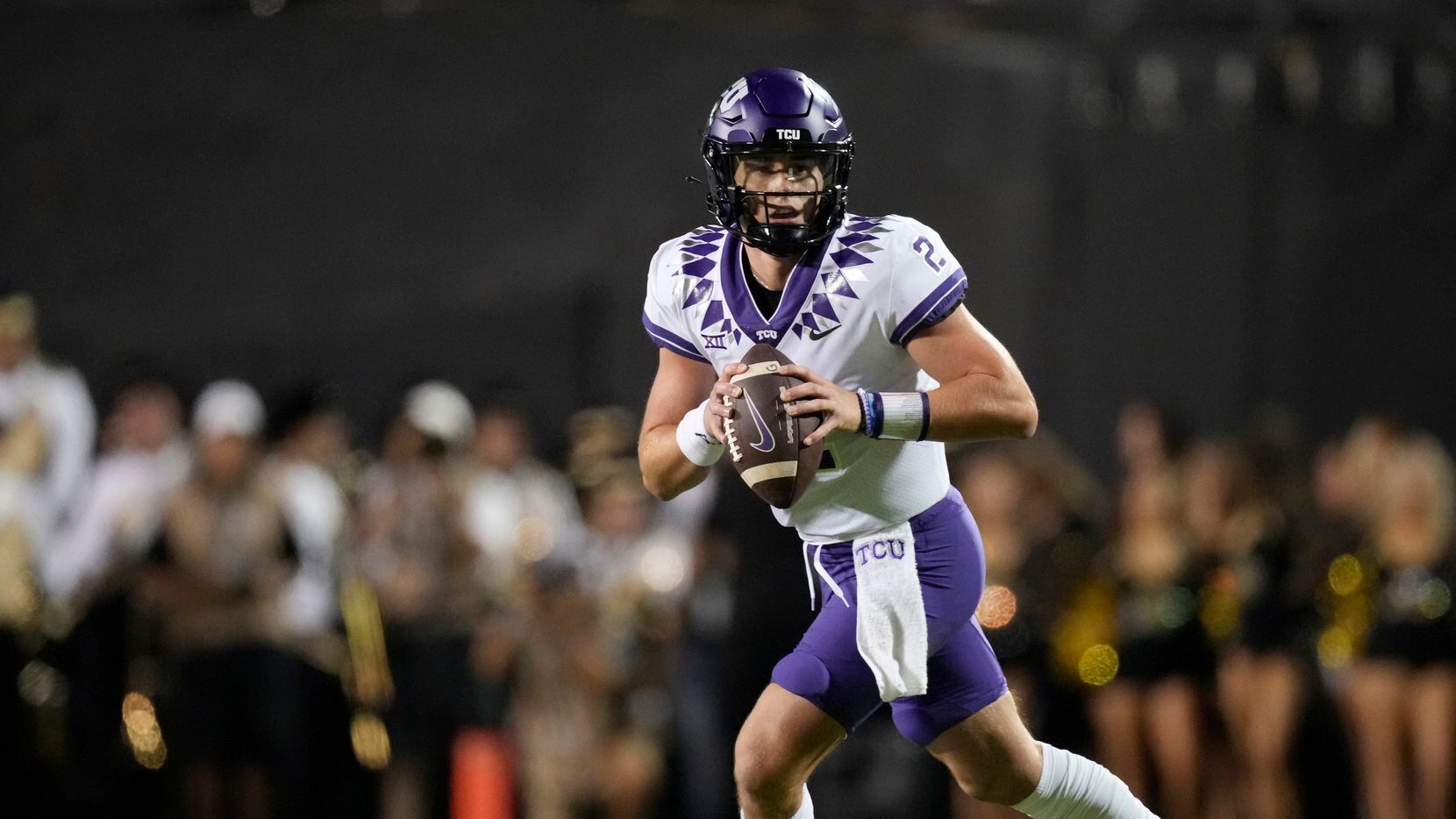 TCU quarterback Chandler Morris rolls out during the first half of the team's NCAA college...