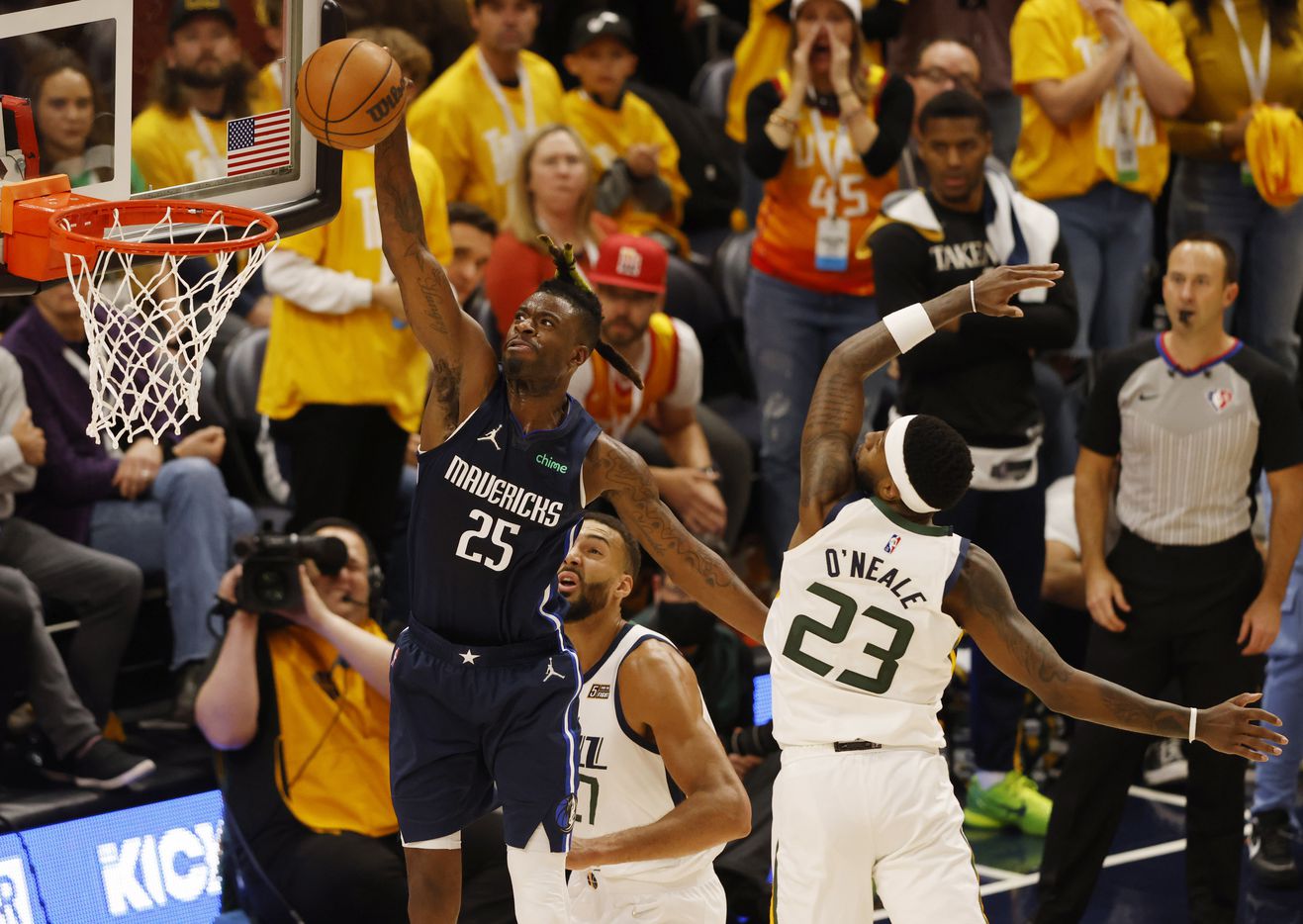 Dallas Mavericks forward Reggie Bullock (25) dunks the ball as Utah Jazz center Rudy Gobert...