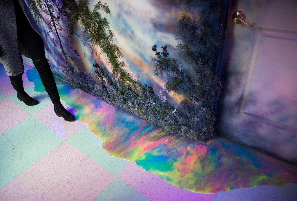 Rainbow "oil" seeps out on to the floor of the lobby, entitled, The Great Conjunction,...