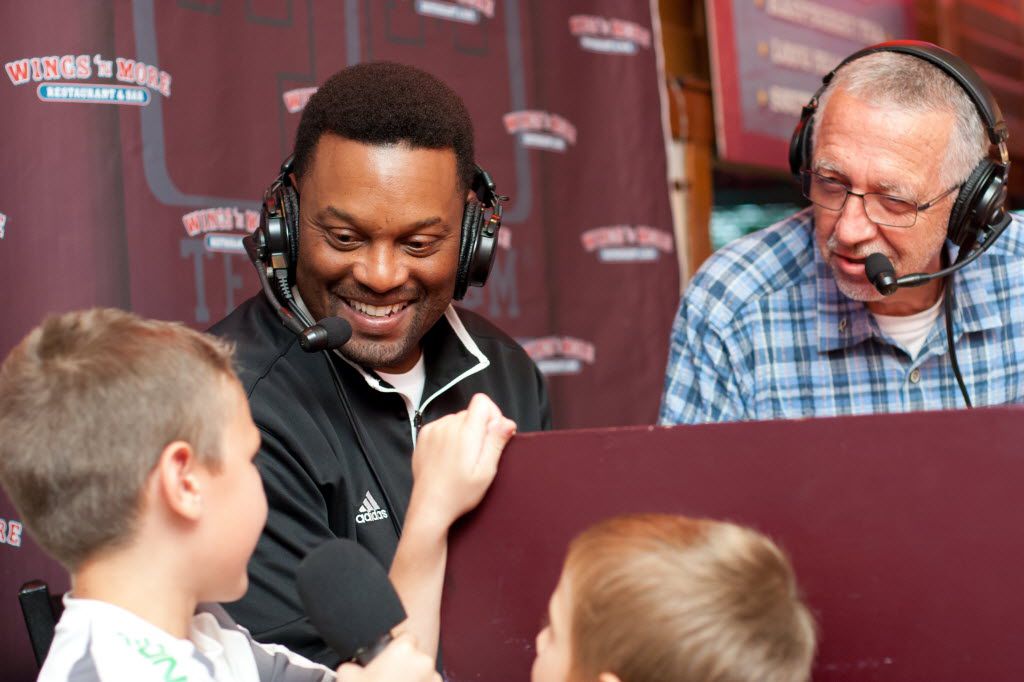 Wyatt Greaves, 8, of Bryan, left, asks a question of Texas A&M head coach Kevin Sumlin, center, during a radio broadcast from Wings n' More in College Station on September 10, 2013. Greaves' question, "How is football going?", received laughs from the packed restaurant including radio "Voice of the Aggies" Dave South, right. (Julia Robinson/Special Contributor) 09132013xNEWS