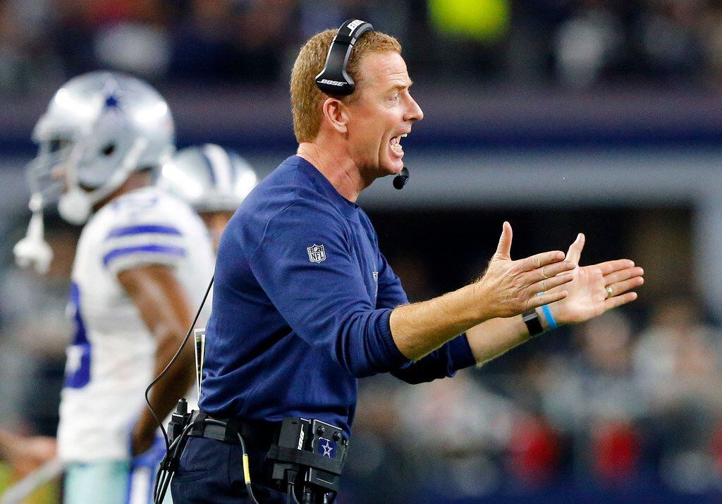 Dallas Cowboys head coach Jason Garrett applauds his offense as they drive on the...