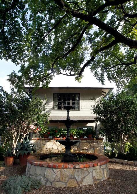 
A three-tiered fountain int the front yard reminds the homeowners of New Orleans courtyards.
