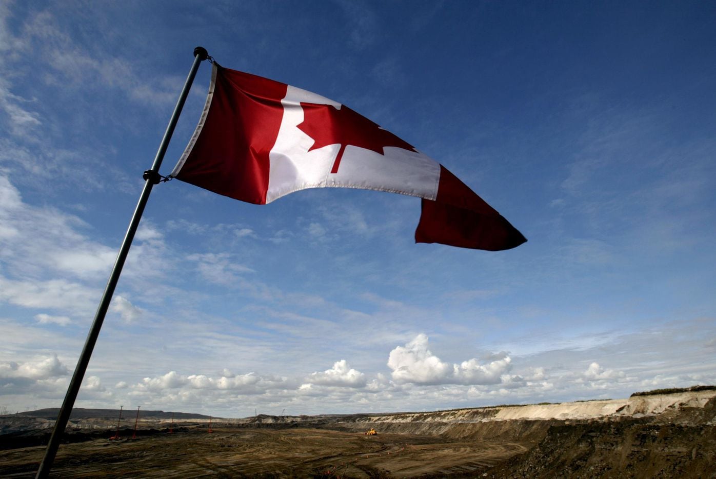2005 FILE PHOTO -- A Canadian flag waves over an expansive strip mine at Syncrude Canada...