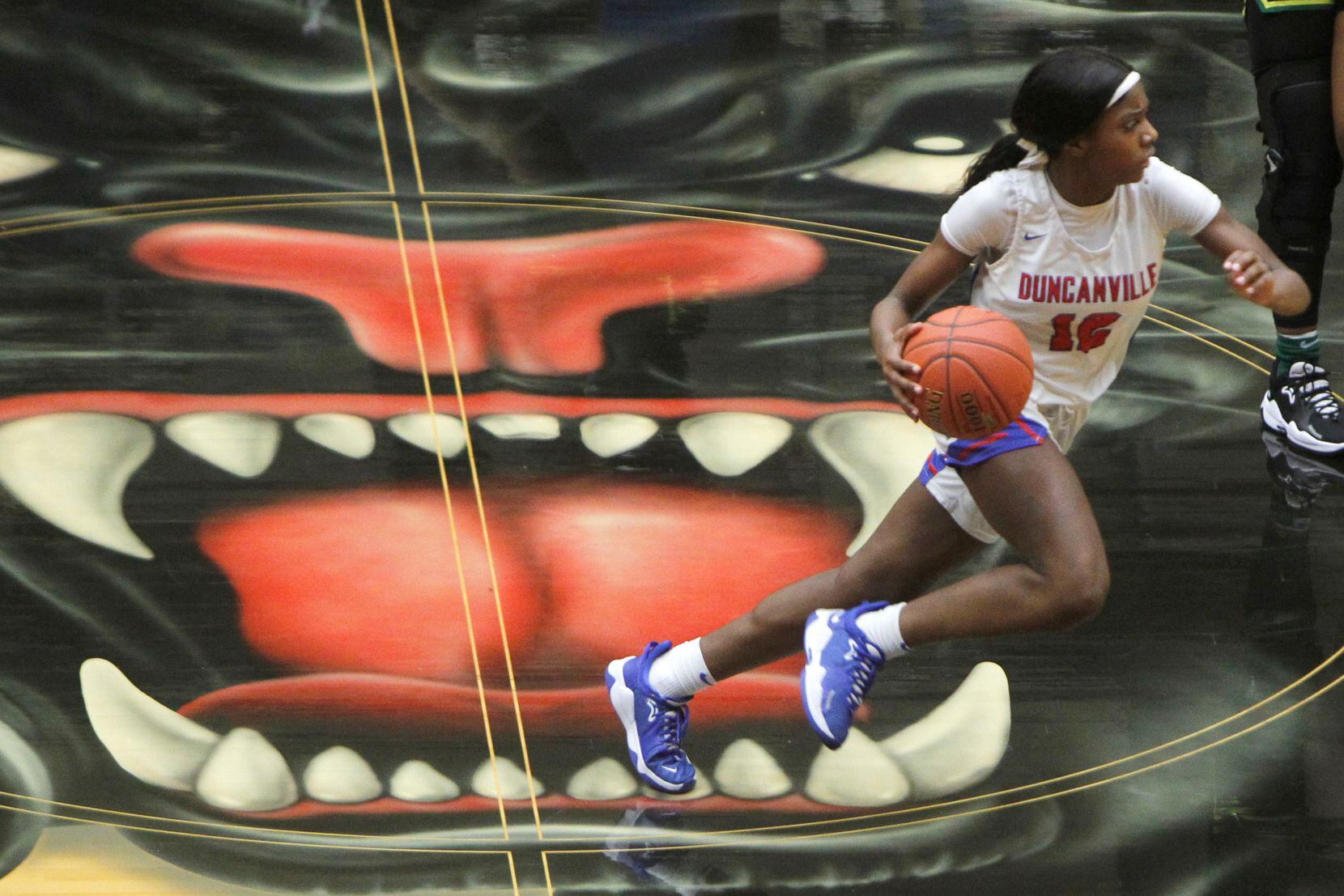 Duncanville guard Kaylinn Kemp (12) drives the ball past mid court during first half action...
