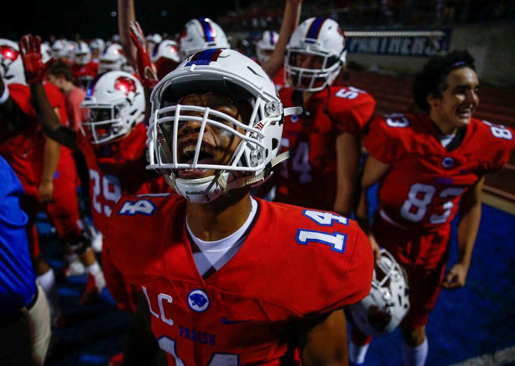Parish Episcopal's Daniel Demery celebrates from the sideline after a Panther touchdown...